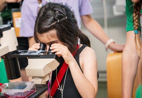 Kind bei der Kinderuni am Mikroskop, Foto: Thomas Suchanek/Vetmeduni