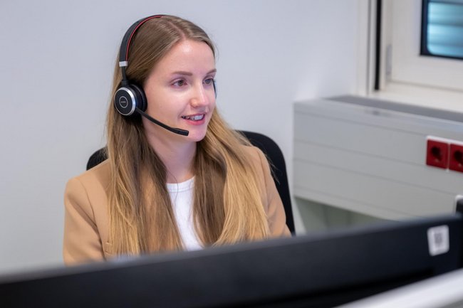 Faculty using a pc wearing a headset